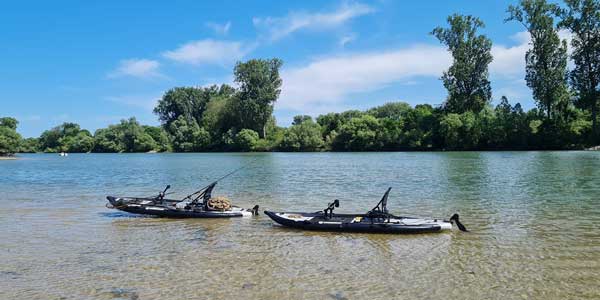 Two inflatable kayaks on a river.