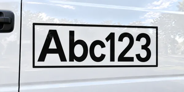 Black letters with a black outline on a white car